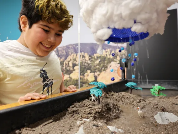 Child participates in precipitation demonstration