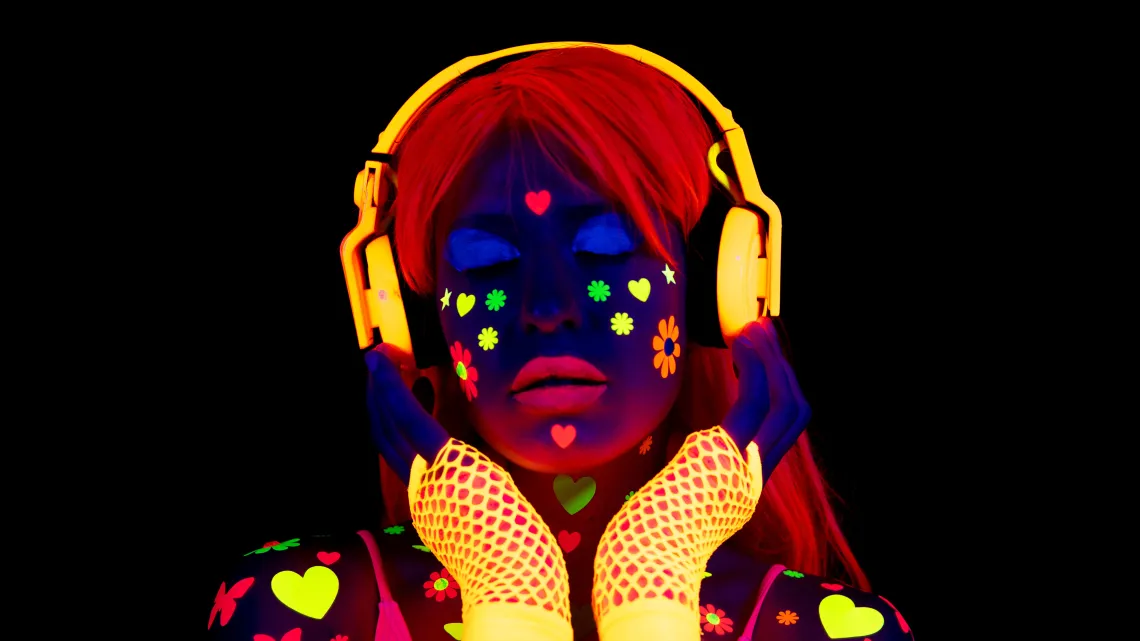 girl in neon lights listening to music